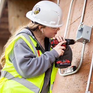 a young woman installing an electrical unit