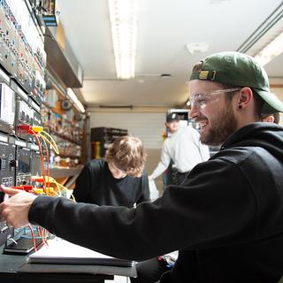 A young man working on circuit boards