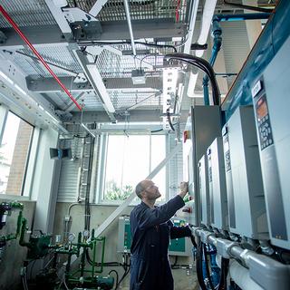 Man looking up at large power equipment
