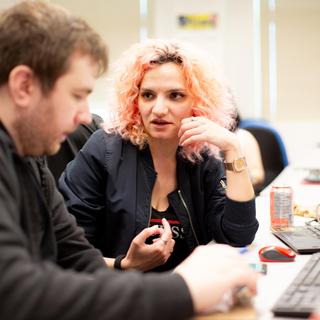  VIU ITAS student describes their final project to an attendee of the ITAS Student Project Fair. 